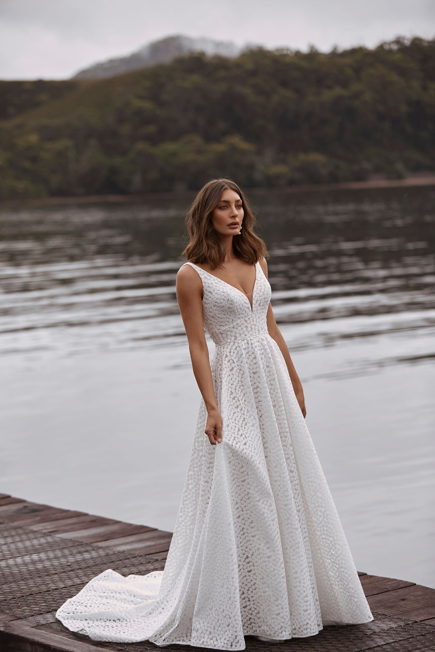 Clara Ml20038 Full Length A Line Gown With Deep V Neckline Fitted Waist All Over Embroidered Lace V Back And Zipper Closure Wedding Dress Madi Lane Bridal 1.jpg