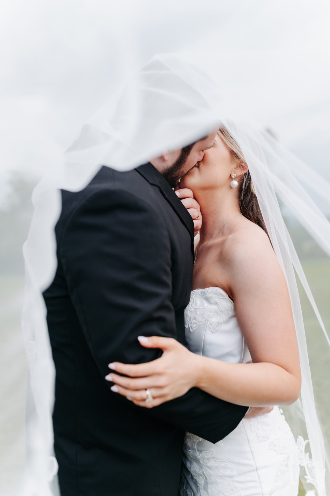 real bride lily in woodrow satin fit and flare sheath strapless wedding dress with lace detail and detachable overskirt